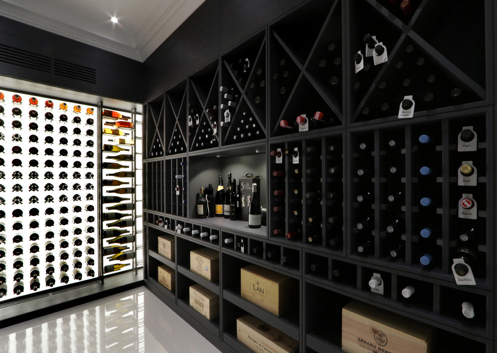This is an example of a mid-sized eclectic wine cellar in London with marble floors and white floor.
