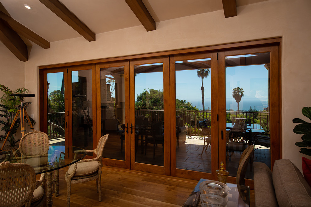 Large mediterranean balcony in Santa Barbara with with fireplace, a roof extension and metal railing.