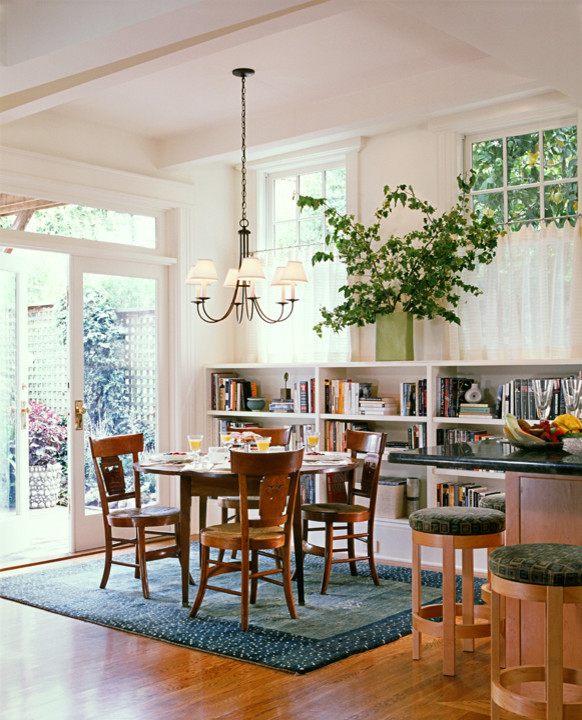 This is an example of a small traditional open plan dining in San Francisco with white walls, bamboo floors and no fireplace.