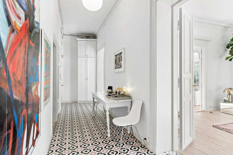Inspiration for a scandinavian hallway in Barcelona with multi-coloured floor.