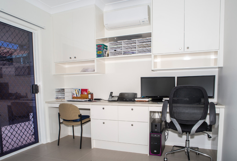 Inspiration for a mid-sized contemporary study room in Gold Coast - Tweed with white walls, carpet and a built-in desk.