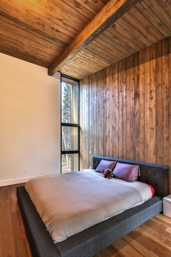 Photo of a mid-sized contemporary master bedroom in Montreal with dark hardwood floors.