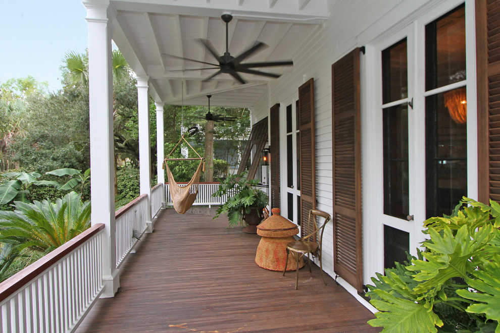 Photo of a mid-sized contemporary front yard verandah in Charleston with decking and a roof extension.