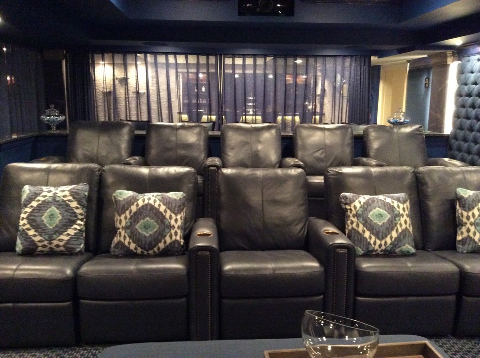 Large transitional home theatre in New York with blue walls, carpet and a projector screen.