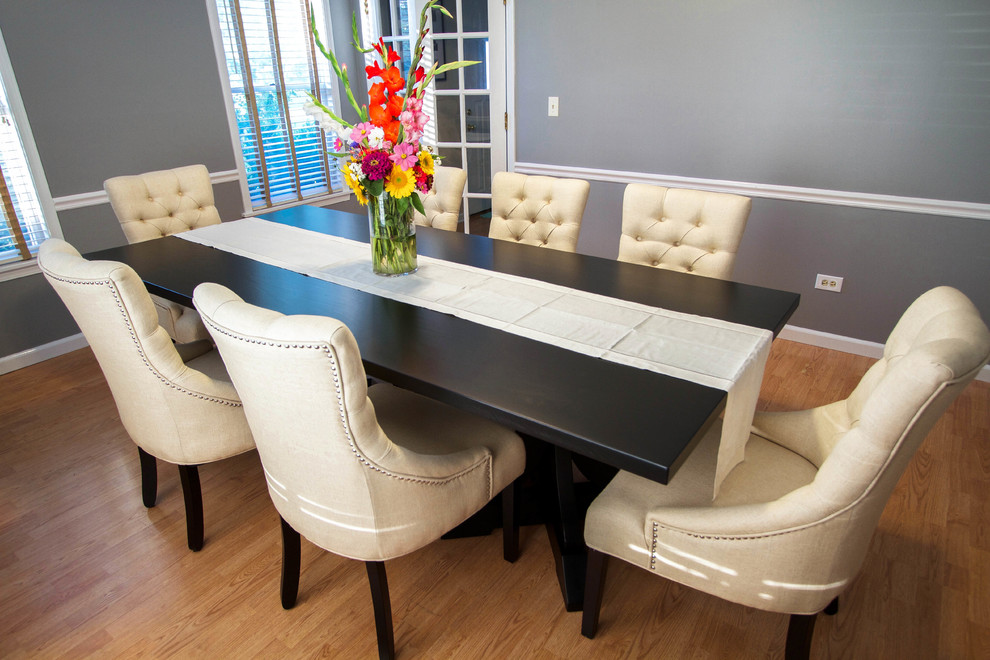 Large transitional medium tone wood floor and brown floor enclosed dining room photo in Chicago with gray walls and no fireplace