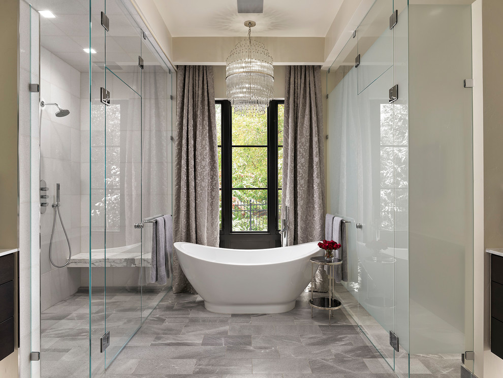 This is an example of a large contemporary master bathroom in Denver with a freestanding tub, beige walls, grey floor, a hinged shower door, a curbless shower and white tile.