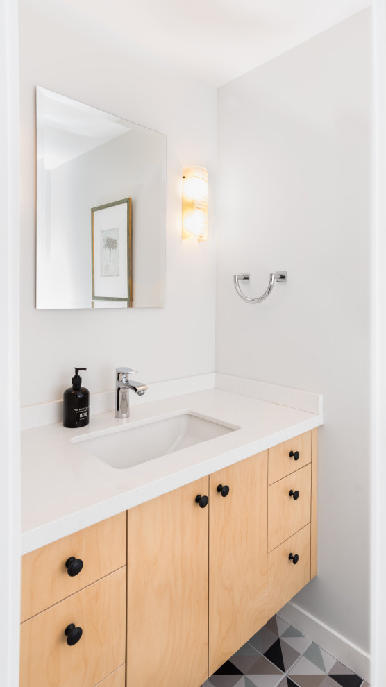 Small midcentury bathroom in San Francisco with flat-panel cabinets, light wood cabinets, white walls, a submerged sink, multi-coloured floors, white worktops, a single sink and a floating vanity unit.