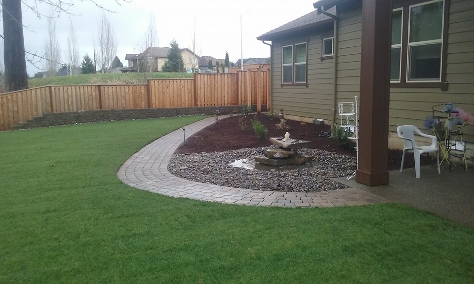Photo of a large eclectic backyard patio in Portland with a water feature and concrete pavers.