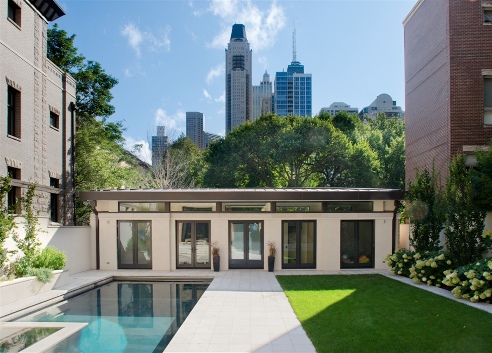 This is an example of a large contemporary stucco white exterior in Chicago with a flat roof.
