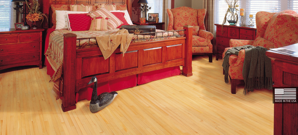 This is an example of a traditional master bedroom in San Francisco with light hardwood floors.