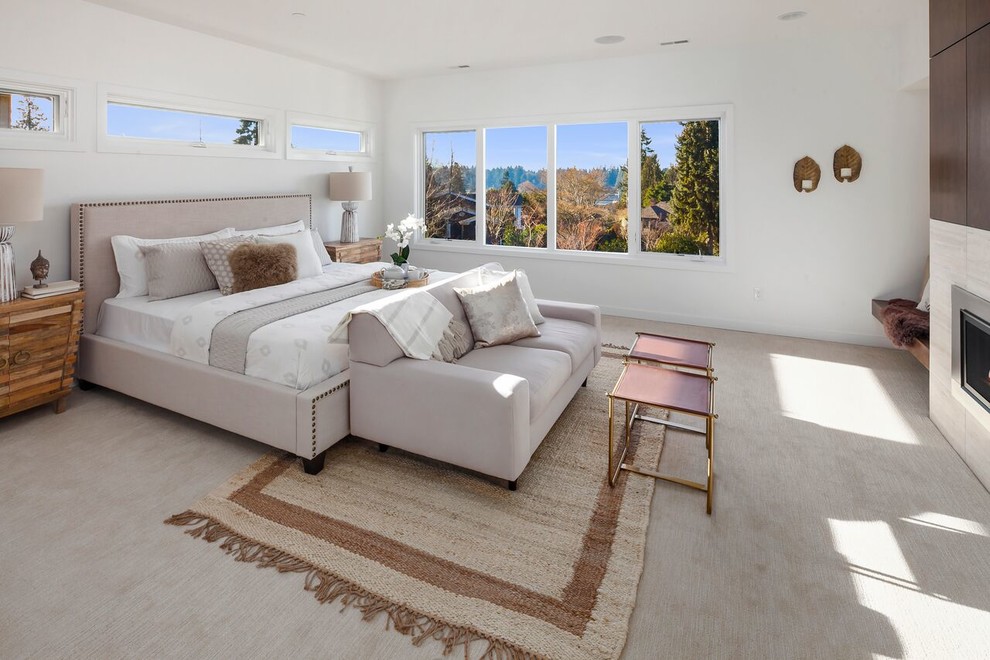 Inspiration for a contemporary master bedroom in Seattle with white walls, carpet, a two-sided fireplace and beige floor.