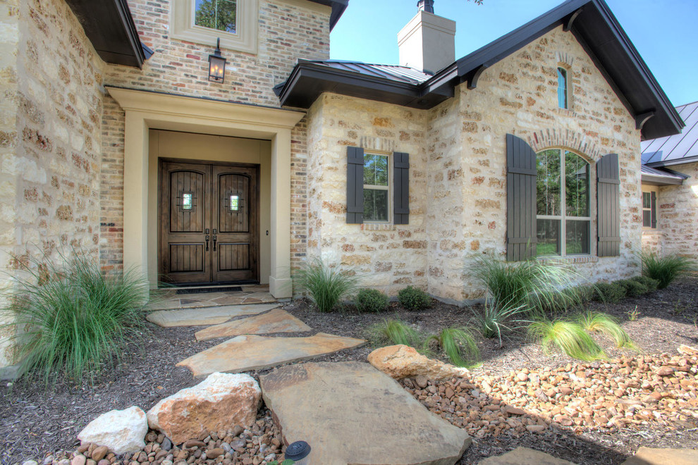 This is an example of a country exterior in Austin with stone veneer.