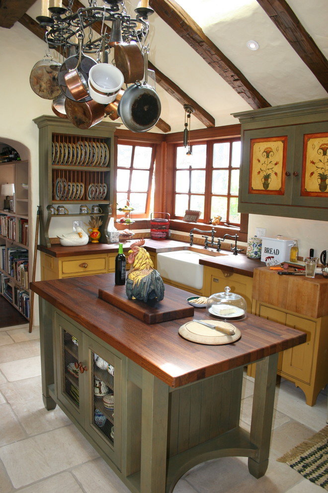 Photo of a mid-sized country u-shaped eat-in kitchen in San Francisco with a farmhouse sink, beaded inset cabinets, distressed cabinets, wood benchtops, panelled appliances, limestone floors and with island.