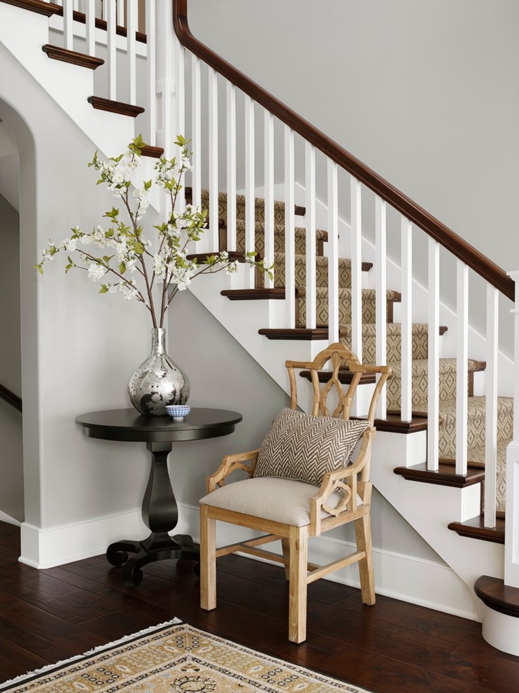 This is an example of a traditional wood l-shaped staircase in Chicago with painted wood risers.