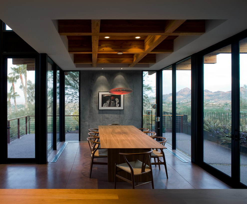 Inspiration for a contemporary dining room in Phoenix with concrete floors.
