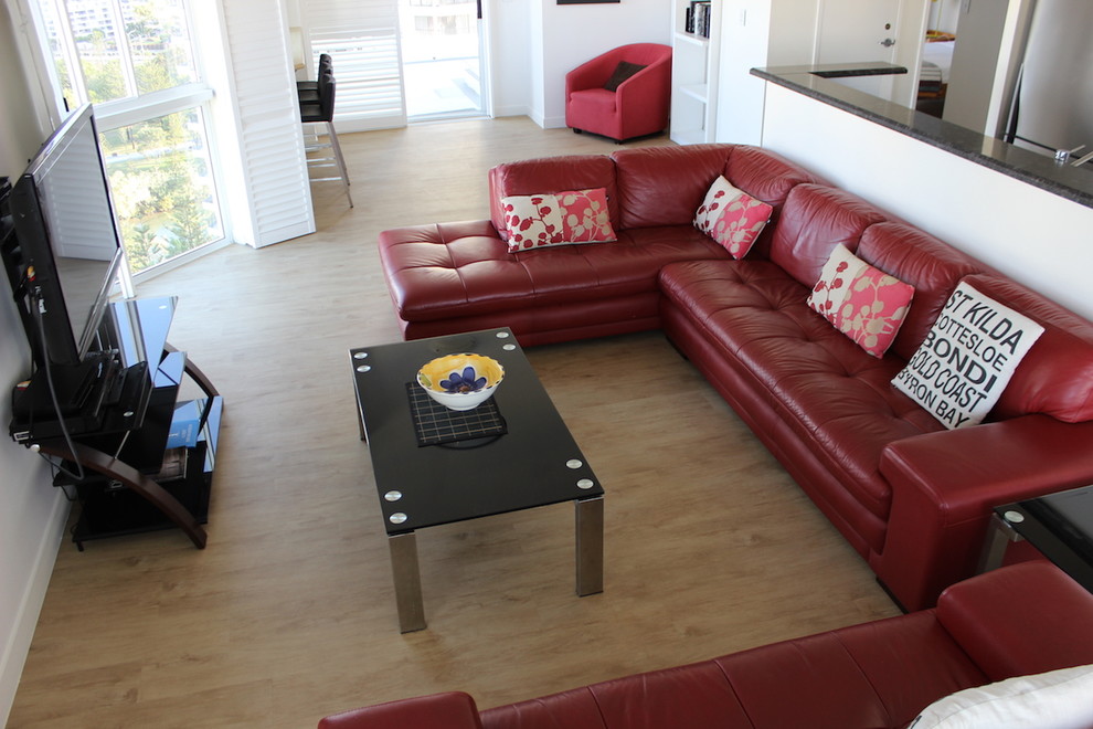 Photo of a mid-sized beach style living room in Gold Coast - Tweed with white walls and vinyl floors.