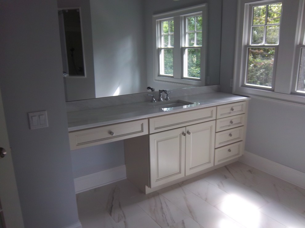 Drop-in bathtub - large transitional master white tile and marble tile marble floor and white floor drop-in bathtub idea with recessed-panel cabinets, white cabinets, white walls, a drop-in sink and solid surface countertops