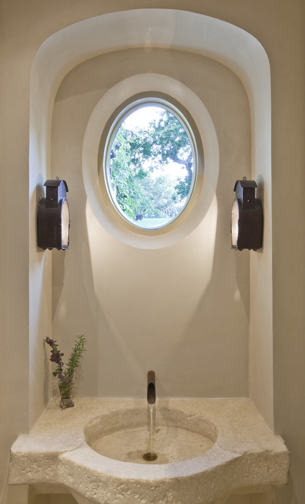 This is an example of a mediterranean powder room in Austin.