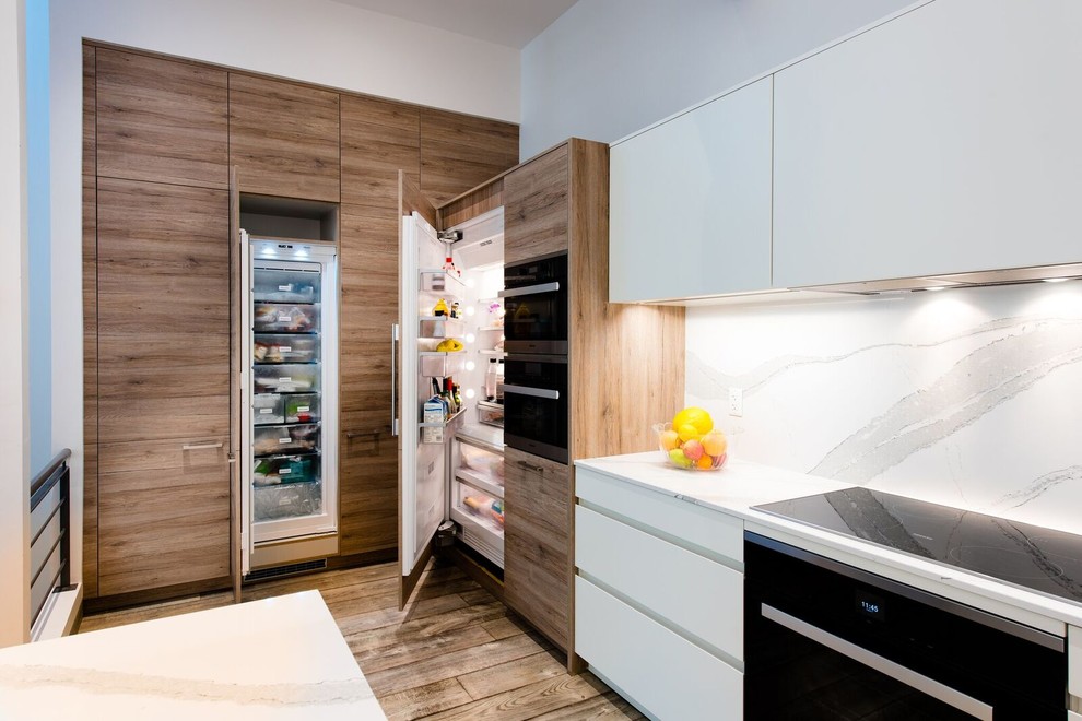 Example of a mid-sized transitional galley medium tone wood floor eat-in kitchen design in Toronto with an undermount sink, flat-panel cabinets, medium tone wood cabinets, quartz countertops, white backsplash, stainless steel appliances and an island