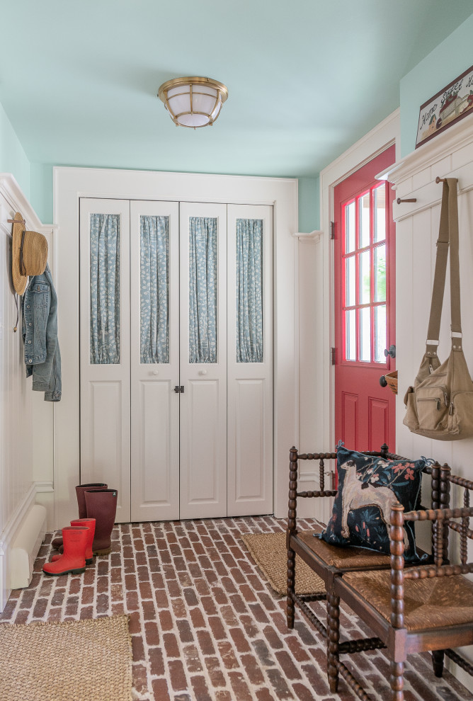 Photo of a small transitional mudroom in Boston with brick floors, a red front door and panelled walls.