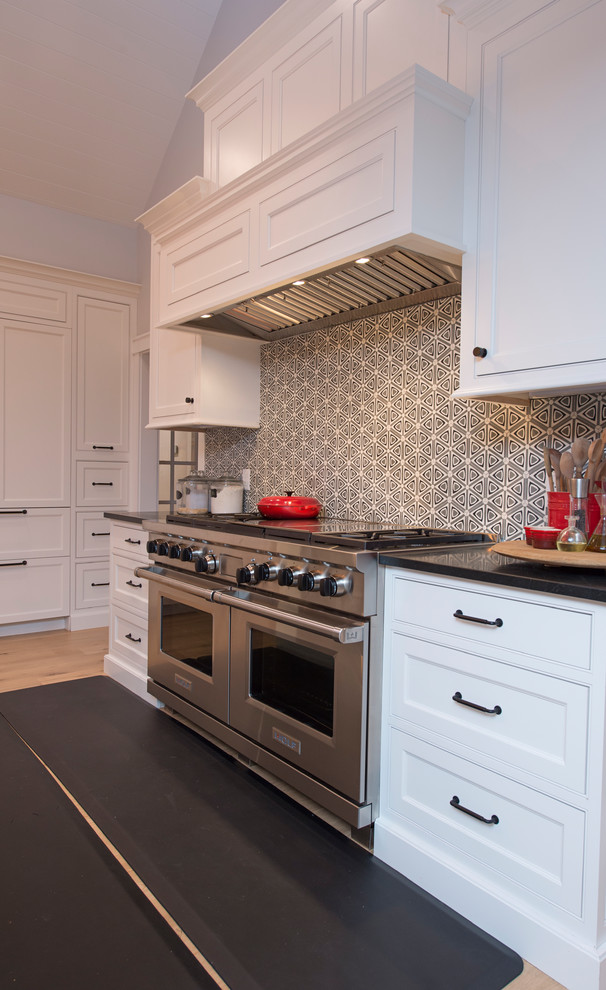 Photo of a large transitional l-shaped open plan kitchen in Boston with flat-panel cabinets, white cabinets, cement tile splashback, white appliances and with island.