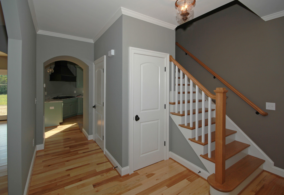 Mid-sized contemporary entry hall in Richmond with grey walls, medium hardwood floors, a single front door and a medium wood front door.