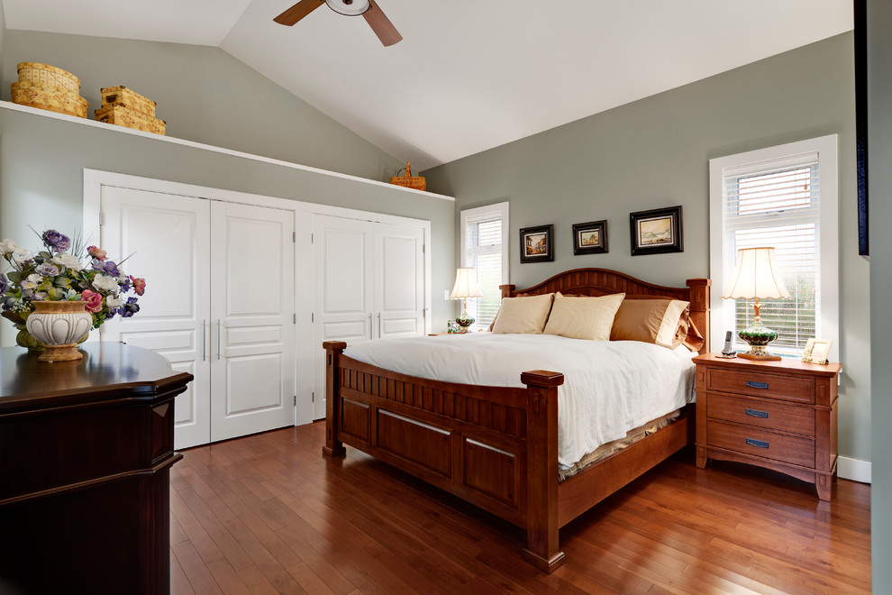 Inspiration for a transitional master bedroom in Vancouver with grey walls and medium hardwood floors.