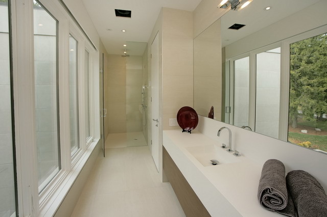 Mid-sized modern 3/4 bathroom in Toronto with flat-panel cabinets, medium wood cabinets, an alcove shower, a two-piece toilet, beige walls, ceramic floors, a trough sink and solid surface benchtops.