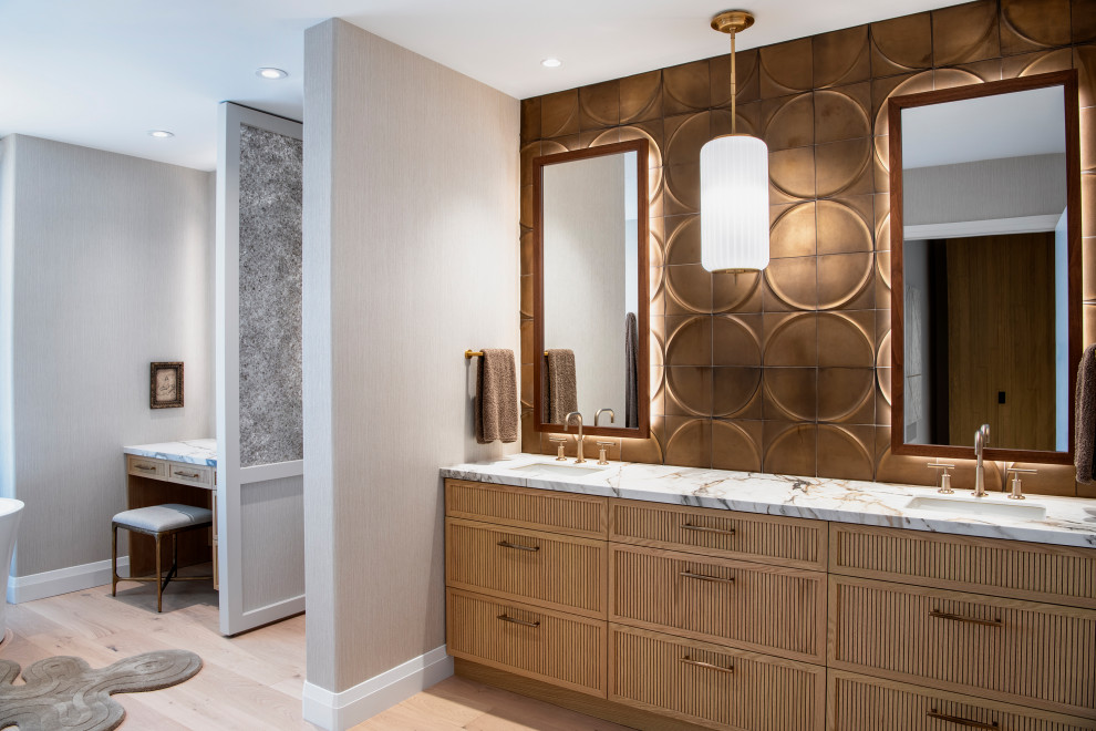 Inspiration for a large eclectic master beige tile light wood floor, double-sink and wallpaper bathroom remodel in Other with beaded inset cabinets, light wood cabinets, a wall-mount toilet, beige walls, an undermount sink, marble countertops, a hinged shower door and a built-in vanity