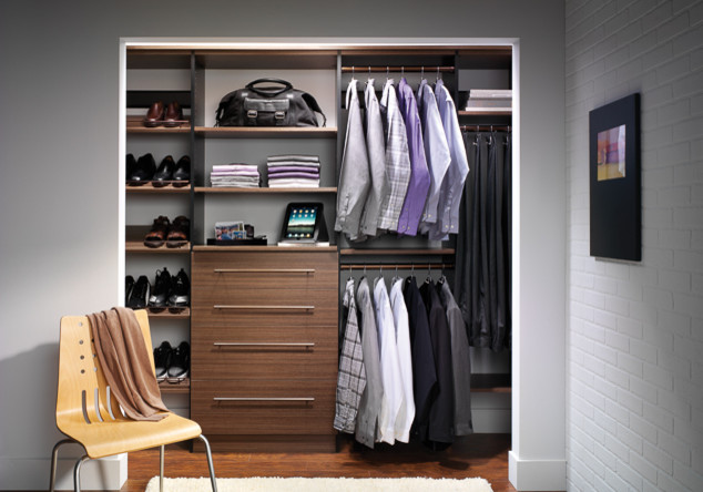 Design ideas for a small transitional men's built-in wardrobe in Jacksonville with flat-panel cabinets, dark wood cabinets, dark hardwood floors and brown floor.