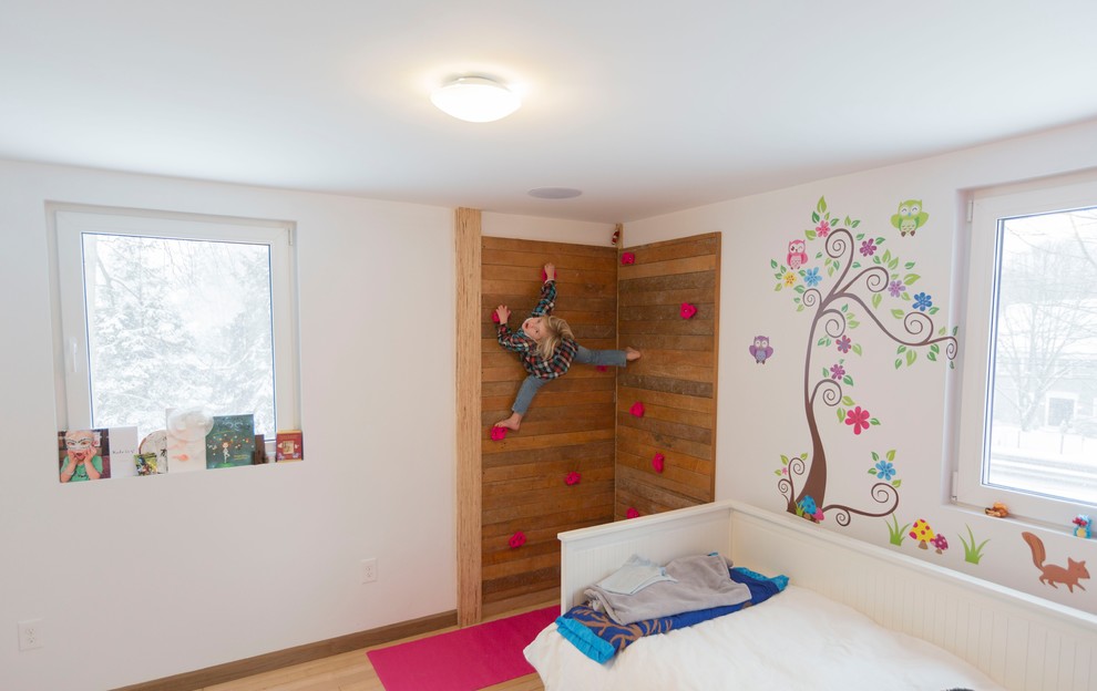 Design ideas for a mid-sized contemporary kids' room for kids 4-10 years old and girls in Boston with white walls, light hardwood floors and beige floor.