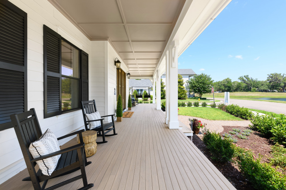 Inspiration for a large country front yard verandah in Jacksonville with with columns and decking.