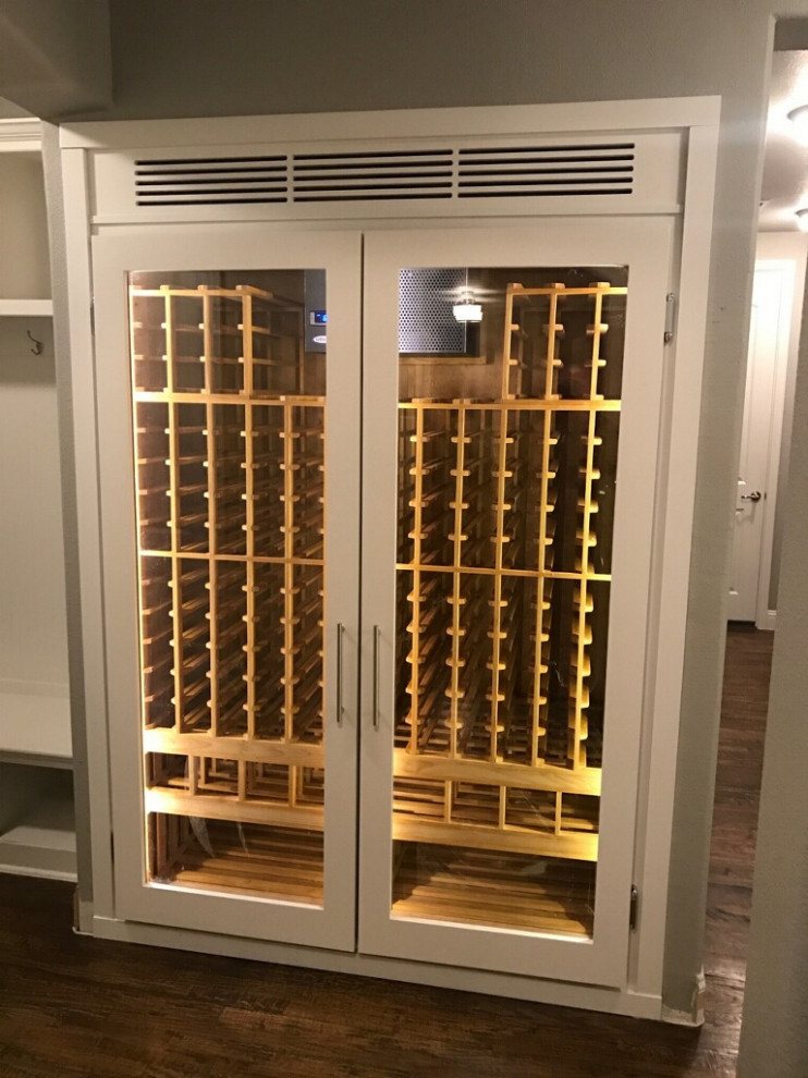 Inspiration for a mid-sized scandinavian wine cellar in Atlanta with dark hardwood floors, storage racks and brown floor.