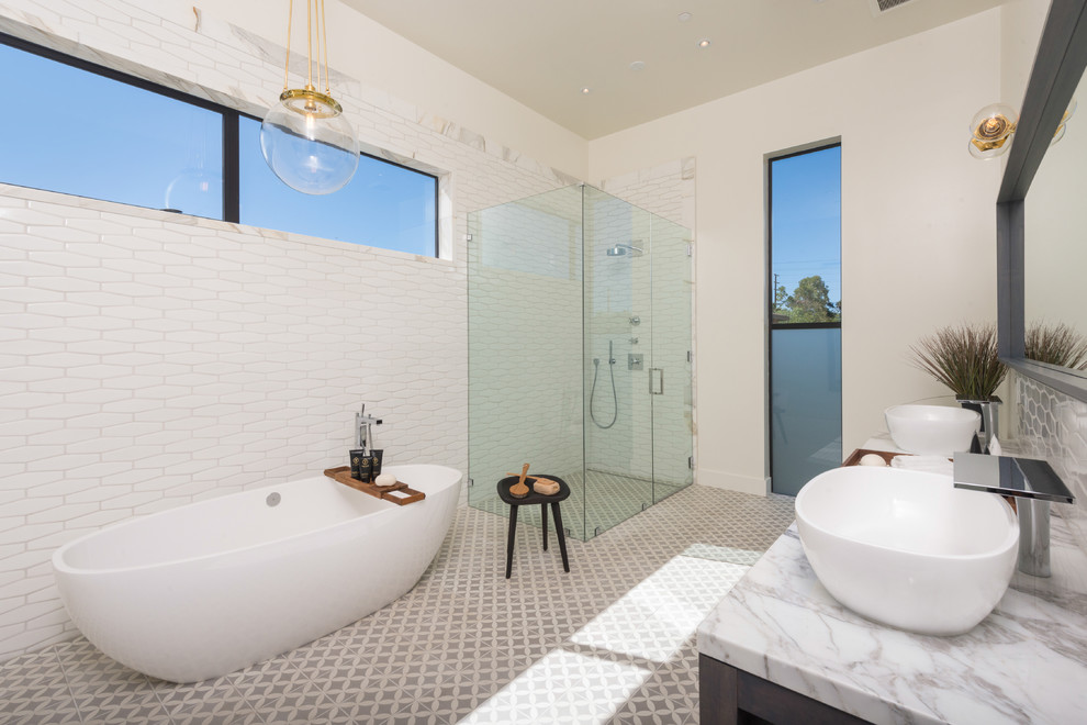 This is an example of a contemporary bathroom in Los Angeles with a vessel sink, a freestanding tub, a corner shower, white tile and white walls.