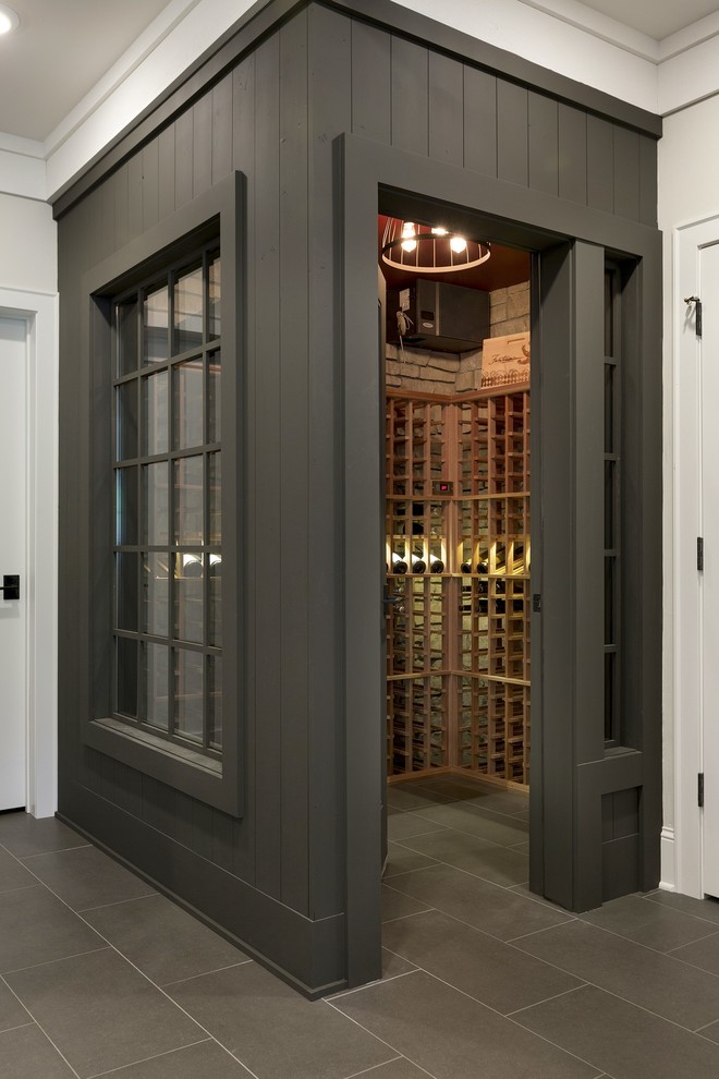 Wine cellar - mid-sized country porcelain tile wine cellar idea in Minneapolis