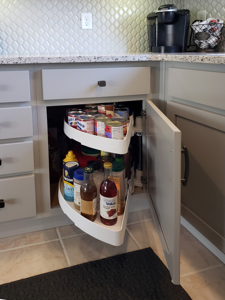 Mid-sized transitional u-shaped ceramic tile and white floor enclosed kitchen photo with an undermount sink, shaker cabinets, gray cabinets, quartz countertops, gray backsplash, stainless steel appliances, no island and gray countertops