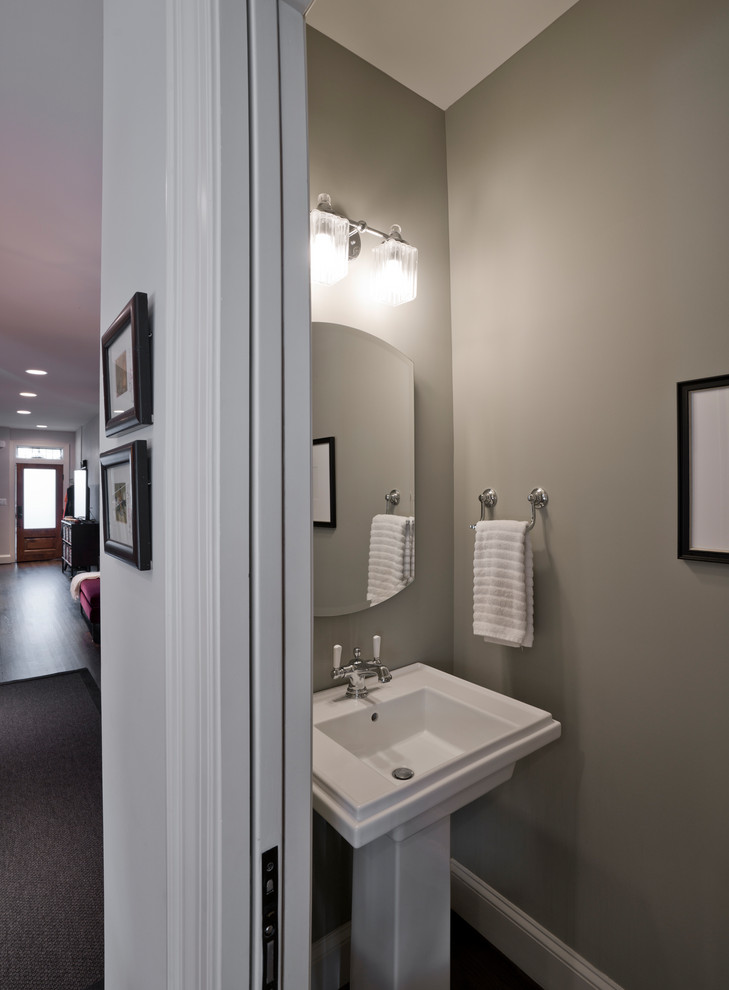 Inspiration for a medium sized contemporary cloakroom in DC Metro with a two-piece toilet, green walls, dark hardwood flooring, a pedestal sink and brown floors.