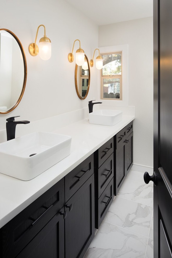 Design ideas for a transitional bathroom in Sacramento with shaker cabinets, black cabinets, marble floors, a vessel sink and quartzite benchtops.