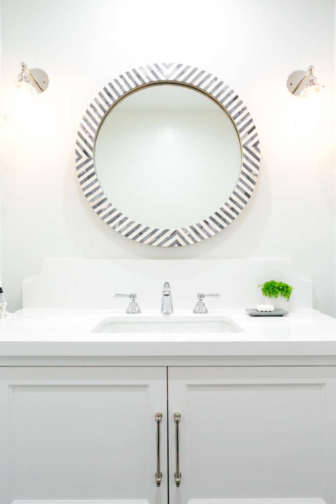 Photo of a mid-sized beach style powder room in Los Angeles with shaker cabinets, white cabinets, white tile, ceramic tile, white walls, ceramic floors, an undermount sink and engineered quartz benchtops.