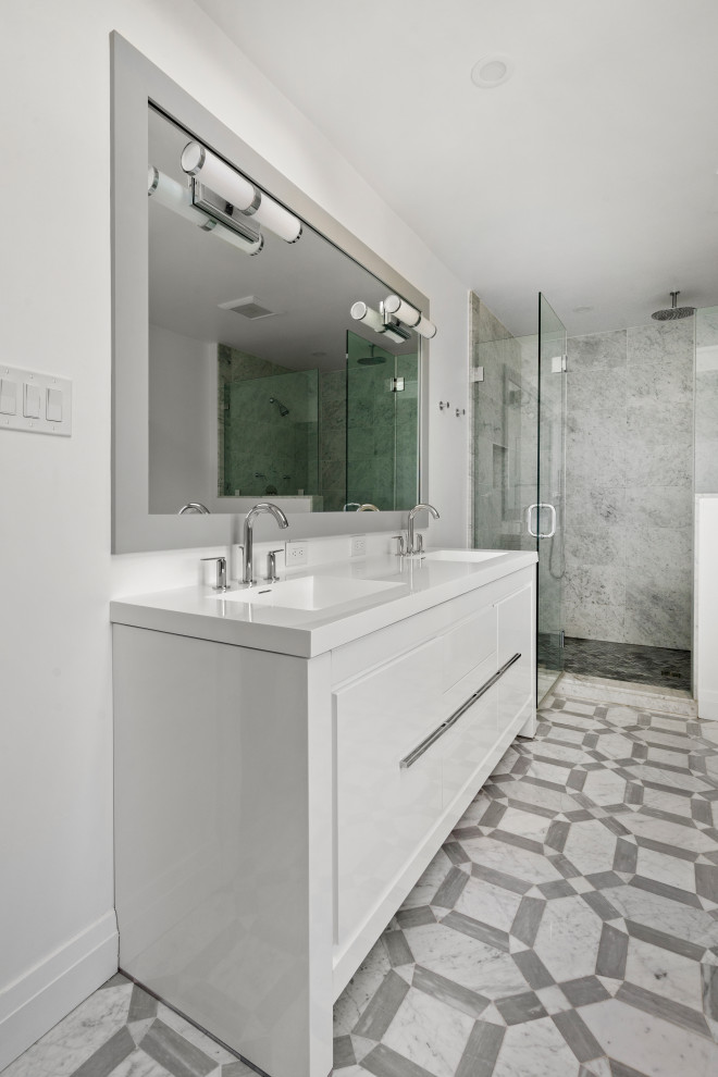 Inspiration for a mid-sized contemporary master bathroom with flat-panel cabinets, white cabinets, a freestanding tub, a curbless shower, gray tile, marble, white walls, marble floors, a console sink, grey floor, a hinged shower door, white benchtops and panelled walls.
