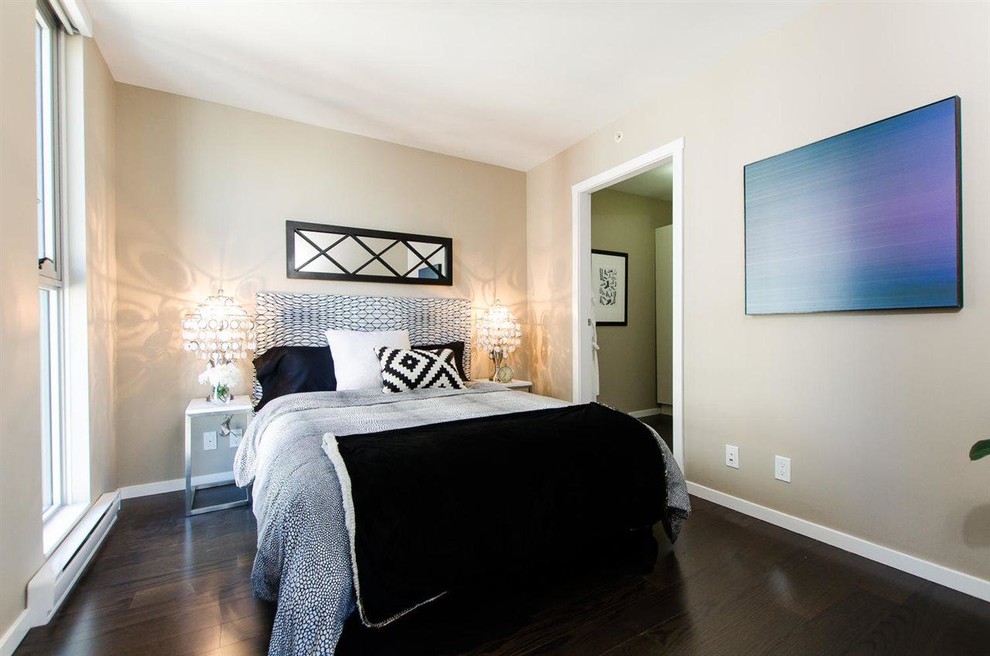 This is an example of a mid-sized contemporary master bedroom in Vancouver with beige walls and dark hardwood floors.