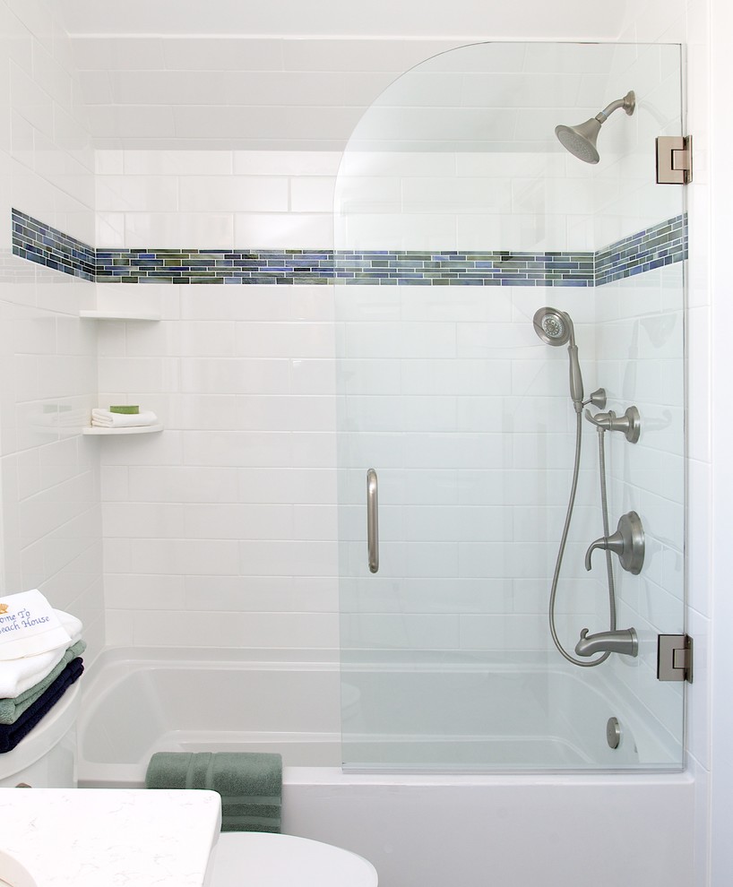 This is an example of a mid-sized contemporary kids bathroom in New York with flat-panel cabinets, light wood cabinets, a drop-in tub, an open shower, white tile, subway tile, an undermount sink and solid surface benchtops.