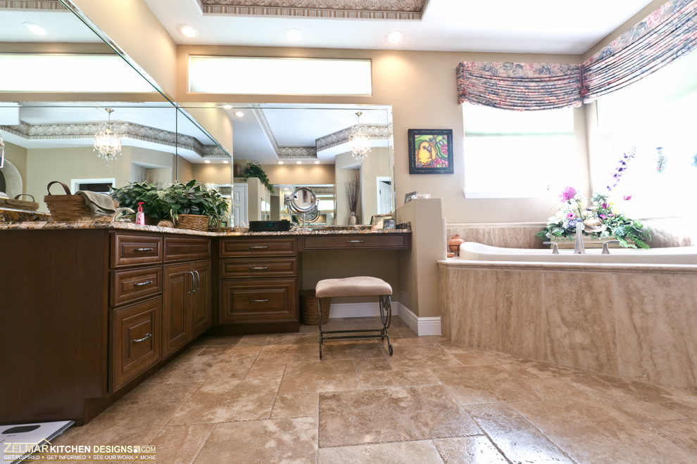 Large traditional master bathroom in Orlando with raised-panel cabinets, dark wood cabinets, granite benchtops, an open shower, beige tile, stone tile and travertine floors.