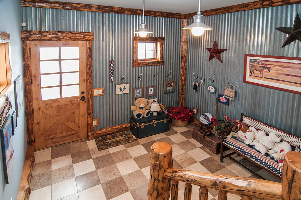 Example of a large mountain style travertine floor foyer design in Denver with multicolored walls and a brown front door