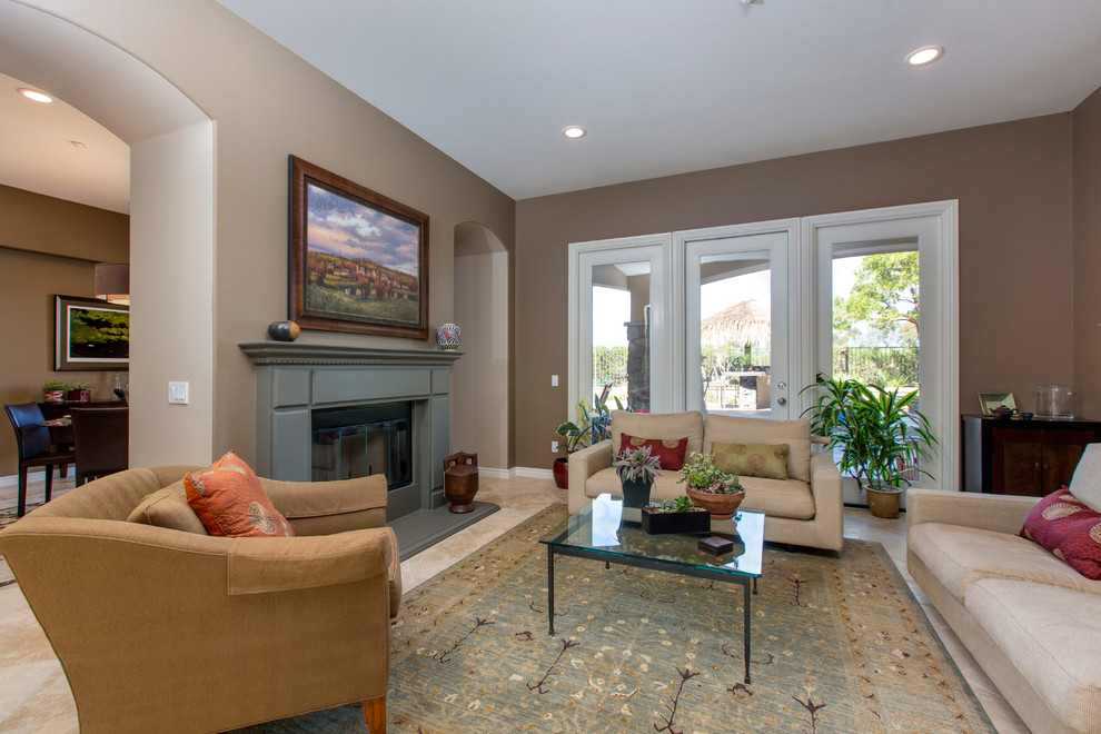 Open concept kitchen - huge transitional l-shaped porcelain tile open concept kitchen idea in Tampa with a single-bowl sink, recessed-panel cabinets, dark wood cabinets, soapstone countertops, beige backsplash, glass sheet backsplash, stainless steel appliances and an island