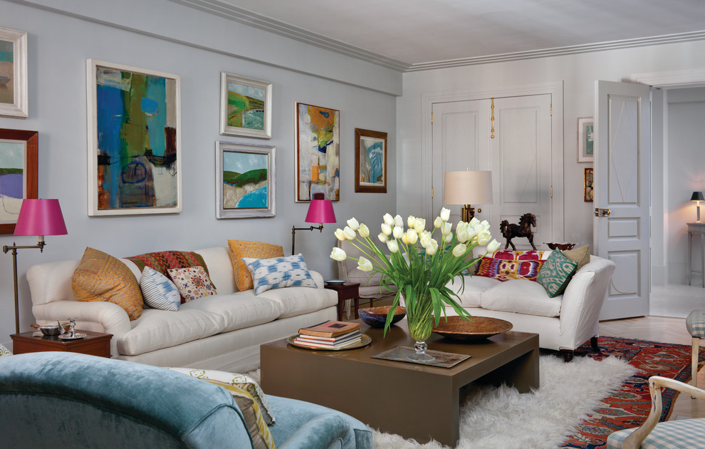 This is an example of an eclectic enclosed living room in New York with white walls.