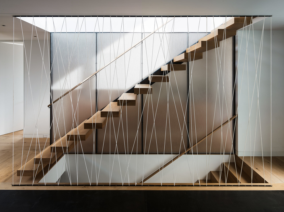 Photo of a mid-sized contemporary wood floating staircase in San Francisco with open risers.