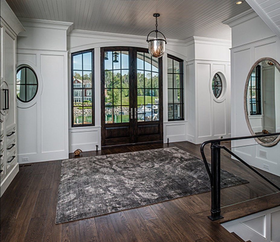 Inspiration for a large transitional dark wood floor and brown floor foyer remodel with white walls and a dark wood front door