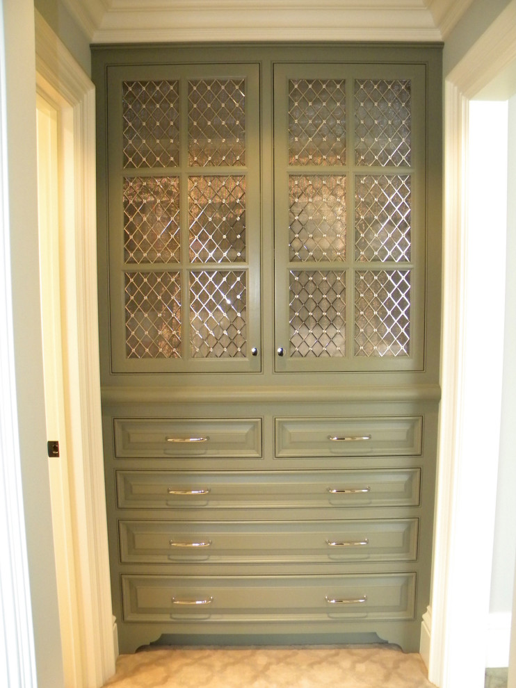 Large traditional women's storage and wardrobe in Indianapolis with raised-panel cabinets, green cabinets, carpet and beige floor.