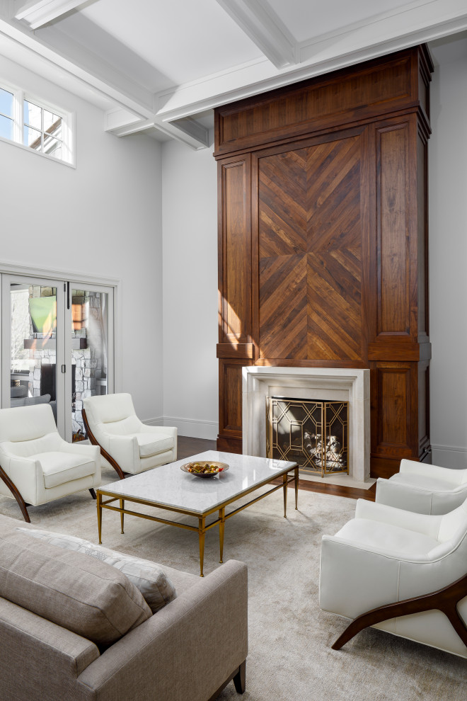Exemple d'un salon chic de taille moyenne et ouvert avec un mur blanc, une cheminée standard, un manteau de cheminée en bois, un sol marron, un plafond à caissons, un sol en bois brun et un bar de salon.